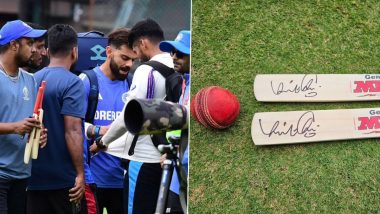 Virat Kohli igives signed bat to young cricketers